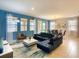 Open-concept living and dining area with stylish furnishings and plenty of natural light from large windows and sliding glass doors at 8039 Oak Shadow Ct, Davenport, FL 33837