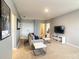 Inviting upstairs living area with modern furniture, plush carpeting, and a wall-mounted flat screen television at 8039 Oak Shadow Ct, Davenport, FL 33837