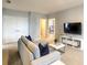 Spacious living room featuring a comfortable gray couch with stylish blue pillows at 8039 Oak Shadow Ct, Davenport, FL 33837