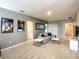 Neutral-toned upstairs living room featuring modern gray furniture, posters, and a sleek entertainment center at 8039 Oak Shadow Ct, Davenport, FL 33837