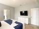 Comfortable main bedroom showcasing a king bed, dresser with television, and ensuite bathroom at 8039 Oak Shadow Ct, Davenport, FL 33837