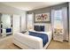 Beautiful main bedroom featuring a king bed, stylish decor, and lots of natural light at 8039 Oak Shadow Ct, Davenport, FL 33837