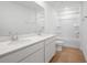 Well-lit bathroom features dual vanities, a large mirror, tub, and ceramic floors at 816 Lake Dell Rd, Dundee, FL 33838