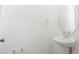 Bathroom featuring white walls, a round mirror and white sink basin at 816 Lake Dell Rd, Dundee, FL 33838