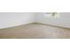 Bedroom featuring light tile flooring, white walls, neutral trim and window overlooking yard at 816 Lake Dell Rd, Dundee, FL 33838