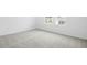 Bright bedroom featuring neutral carpet, base molding and double windows for natural light at 816 Lake Dell Rd, Dundee, FL 33838