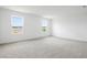 Bright bonus room featuring neutral carpet and double windows for natural light at 816 Lake Dell Rd, Dundee, FL 33838