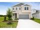 Charming two-story home with an attached garage and well-maintained front lawn featuring manicured landscaping at 816 Lake Dell Rd, Dundee, FL 33838