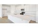 Bright kitchen featuring an island, stainless steel appliances, and white cabinets at 816 Lake Dell Rd, Dundee, FL 33838