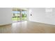 Bright living room featuring tiled floors and sliding glass doors that lead to a green backyard at 816 Lake Dell Rd, Dundee, FL 33838