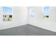 Neutral bedroom with carpet, white walls, and natural light from the three windows at 824 Lake Dell Rd, Dundee, FL 33838