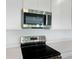 Close-up showcasing the stainless steel microwave and electric range in this modern kitchen at 824 Lake Dell Rd, Dundee, FL 33838