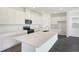 Bright, modern kitchen featuring white cabinets, an island, and stainless steel appliances at 824 Lake Dell Rd, Dundee, FL 33838