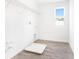 Functional laundry room with tile flooring, shelving, and natural light at 824 Lake Dell Rd, Dundee, FL 33838