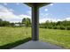 Covered patio showing a spacious backyard with lush lawn and a beautiful green space at 828 Lake Dell Rd, Dundee, FL 33838