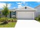 Inviting single-story home with a two-car garage, pristine driveway, and tastefully painted exterior with matching shutters at 828 Lake Dell Rd, Dundee, FL 33838