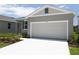 Well-maintained home featuring a two-car garage, ample driveway space, and freshly landscaped surroundings at 828 Lake Dell Rd, Dundee, FL 33838