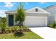 Charming single-story home with a two-car garage, beautifully landscaped front yard, and neutral-toned exterior at 828 Lake Dell Rd, Dundee, FL 33838