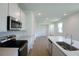 Contemporary kitchen boasting stainless steel appliances, an island with seating, and ample natural light, perfect for modern living at 828 Lake Dell Rd, Dundee, FL 33838