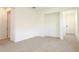 Bright, airy living room featuring stylish tile flooring, neutral walls, and an open layout leading to the entryway at 828 Lake Dell Rd, Dundee, FL 33838