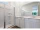 Bathroom with glass shower and double sink vanity at 832 Lake Dell Rd, Dundee, FL 33838