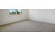 Bright bedroom featuring a window and plush carpeting at 832 Lake Dell Rd, Dundee, FL 33838