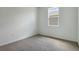 Cozy bedroom featuring a window and plush carpeting at 832 Lake Dell Rd, Dundee, FL 33838