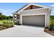 A single-Gathering home featuring a two-car garage, landscaped front yard, and a modern architectural design at 832 Lake Dell Rd, Dundee, FL 33838