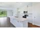 Modern kitchen with white cabinetry, stainless steel appliances, and a center island with quartz countertops at 832 Lake Dell Rd, Dundee, FL 33838