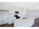 Bright kitchen featuring white cabinets, stainless steel appliances, and a quartz countertop island at 832 Lake Dell Rd, Dundee, FL 33838