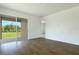 Spacious living area with wood-look tile flooring and sliding glass doors leading to an outdoor patio at 832 Lake Dell Rd, Dundee, FL 33838