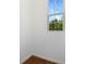 Bright, minimalist room featuring wood-look tile flooring, fresh white walls, and ample natural light at 832 Lake Dell Rd, Dundee, FL 33838