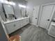 Bathroom with double vanity, modern fixtures and tile floors at 9803 Sweetleaf St, Orlando, FL 32827