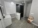 Modern bathroom featuring a glass-enclosed shower, white cabinetry and tile floors at 9803 Sweetleaf St, Orlando, FL 32827