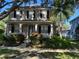 Charming two-story home featuring lush landscaping, a covered porch and large windows at 9803 Sweetleaf St, Orlando, FL 32827
