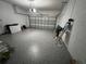 Spacious garage with coated floor and plenty of room for storage and vehicles at 9803 Sweetleaf St, Orlando, FL 32827
