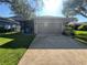 Exterior shot of a home showcasing the garage, driveway, and landscaping at 9803 Sweetleaf St, Orlando, FL 32827