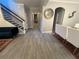 Inviting home interior with a long hallway, tiled flooring, and a stairway at 9803 Sweetleaf St, Orlando, FL 32827