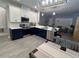 Modern kitchen featuring stainless steel appliances, two-tone cabinets and a tile backsplash at 9803 Sweetleaf St, Orlando, FL 32827