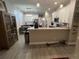 Bright open kitchen with stainless steel appliances, white cabinets and breakfast bar at 9803 Sweetleaf St, Orlando, FL 32827