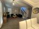 Spacious living area with tile floors, staircase, comfortable seating and modern decor at 9803 Sweetleaf St, Orlando, FL 32827
