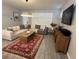 Cozy living room with modern decor, tile floors, comfortable seating and plenty of natural light at 9803 Sweetleaf St, Orlando, FL 32827