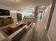 Open-concept living area with modern decor, tile floors, and a view of the kitchen at 9803 Sweetleaf St, Orlando, FL 32827