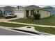 Single story home featuring a two-car garage, manicured lawn, and traditional design at 1104 Star Ruby Ln, Winter Haven, FL 33880