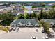 Aerial view of townhomes with parking and a lush green park at 1150 Jade East Ln, Kissimmee, FL 34744