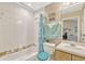 Clean bathroom with a combined tub and shower, tiled walls, and a vanity with cabinets at 1150 Jade East Ln, Kissimmee, FL 34744