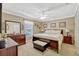 Well-lit bedroom features neutral walls, ceiling fan, and a dark wood furniture set at 1150 Jade East Ln, Kissimmee, FL 34744