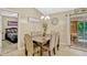 Dining room includes a six-chair table, decorative lighting, access to the screened porch, and an open layout at 1150 Jade East Ln, Kissimmee, FL 34744