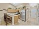 Bright kitchen features stainless appliances, breakfast bar, decorative tile backsplash, and neutral color palette at 1150 Jade East Ln, Kissimmee, FL 34744