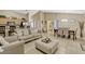 Open concept: Kitchen, dining, and living rooms with tile flooring, neutral walls, and vaulted ceilings at 1150 Jade East Ln, Kissimmee, FL 34744
